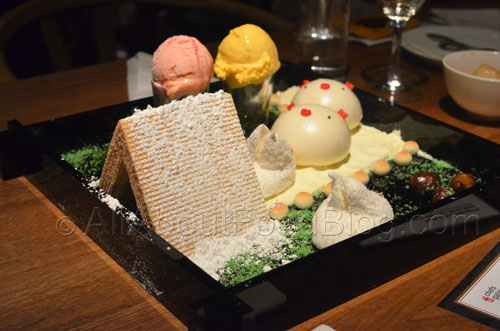 Signature “Piggy Face” sesame bun and “Totoro” marshmallow arranged in an edible garden setting, beautifully presented and served with ice cream.
